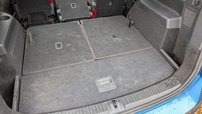 Dirty VW Touran boot in St Ives, Cambridgeshire before interior detailing, with dust, debris and pet hair visible on carpets.