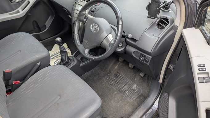 Toyota Yaris in Wisbech, Cambridgeshire before interior car detailing, with staining on seats, dirt on mats, and dust on plastics.