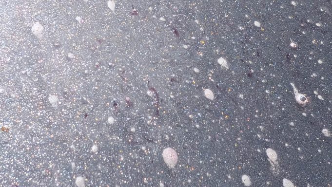 Close-up of Toyota Yaris paintwork in Wisbech, Cambridgeshire during decontamination stage, showing contaminants lifting from the surface.
