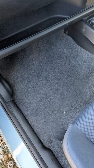 Clean rear footwell carpet of a Honda Jazz in Market Deeping after interior detailing and carpet extraction.