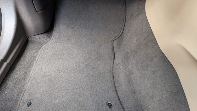 Jaguar XF Driver Carpet Before Shampooing - Bourne, Lincolnshire Jaguar XF driver footwell before carpet shampooing and interior detailing in Bourne, Lincolnshire with dirt and debris across the carpet.