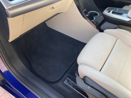 BMW iX1 passenger footwell after interior detailing and extraction in Wittering, Peterborough