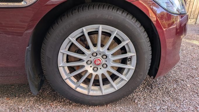 Close-up of a Jaguar XF alloy wheel in Cambridge after detailing, restored to a clean finish with dirt and brake dust removed.