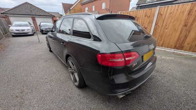 Rear of a black Audi S4 Avant in Huntingdon, Cambridgeshire before detailing, showing road dust and dull finish. Rear of a black Audi S4 Avant in Huntingdon, Cambridgeshire before detailing.