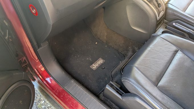 Jeep interior footwell in Mildenhall Suffolk with carpets showing debris before full interior detailing.