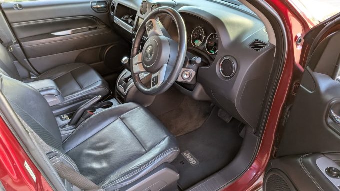Jeep interior in Mildenhall Suffolk after detailing, black leather seats, dashboard and footwell restored to a clean finish