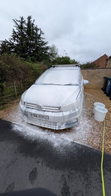 VW Touran in St Ives, Cambridgeshire covered in thick snow foam during exterior car detailing, pre-wash stage.