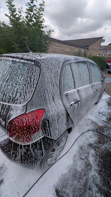 Toyota Yaris in Wisbech, Cambridgeshire covered in thick snow foam during exterior detailing process.