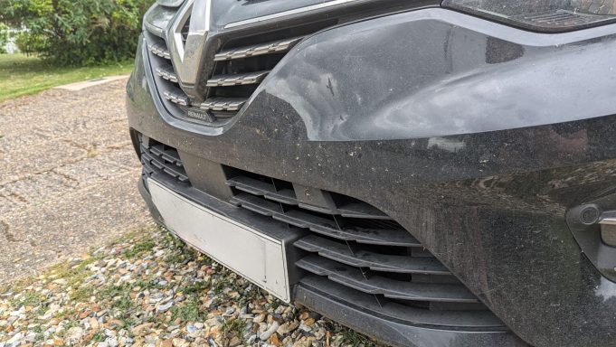 Renault Clio front bumper before detailing in Glinton, Peterborough, showing dirt and bug contamination