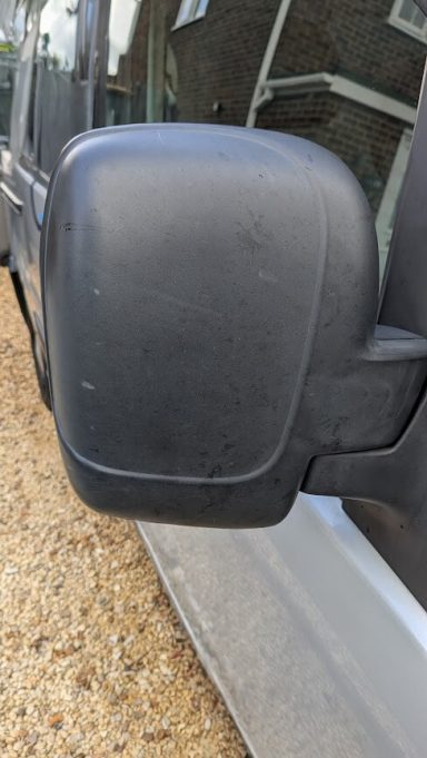Faded black wing mirror on a Citroen Berlingo van in Peterborough before exterior trim restoration