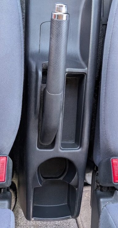 Clean front centre console of a Honda Jazz in Market Deeping, Lincolnshire after interior detailing, with storage compartments cleared.