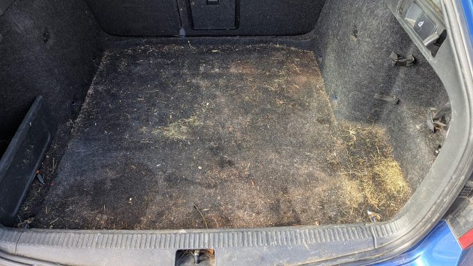 Skoda boot before detailing in Peterborough, Cambridgeshire with sand staining, pet hair and ingrained debris across the carpet