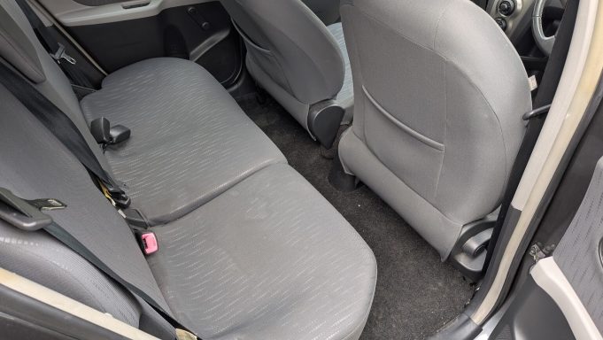 Rear seats and carpet of a Toyota Yaris in Wisbech, Cambridgeshire after interior detailing, with stains removed and upholstery refreshed.