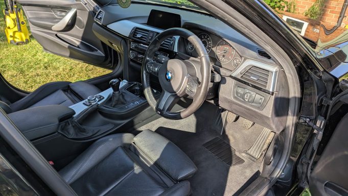 Clean driver’s footwell of a BMW 3 Series in Stilton, Peterborough after deep interior detail, with carpets and trim restored.