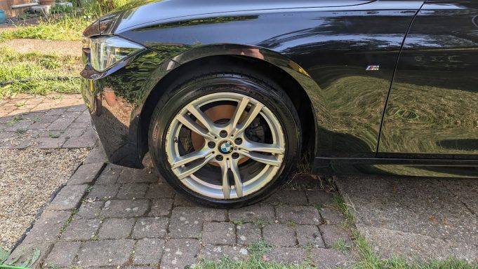 Clean alloy wheel of a BMW 3 Series in Stilton, Peterborough after detailing, showing restored shine and tyre dressing.