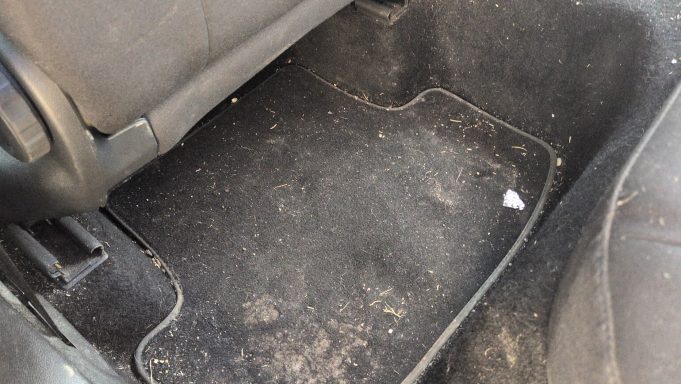 Rear floor mats of a Seat Ateca in Ely showing dirt, debris, and staining before interior detailing.