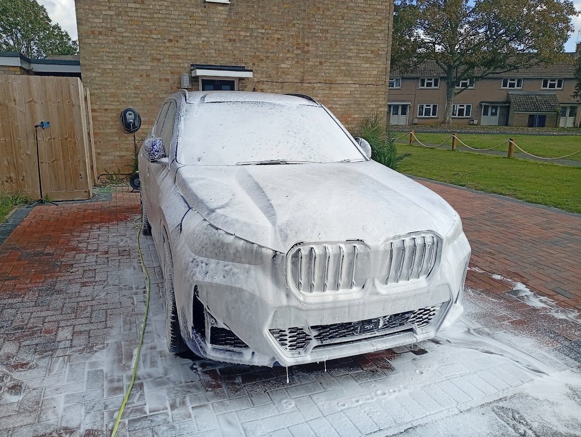 BMW iX1 covered in Snow foam during detail in Peterborough