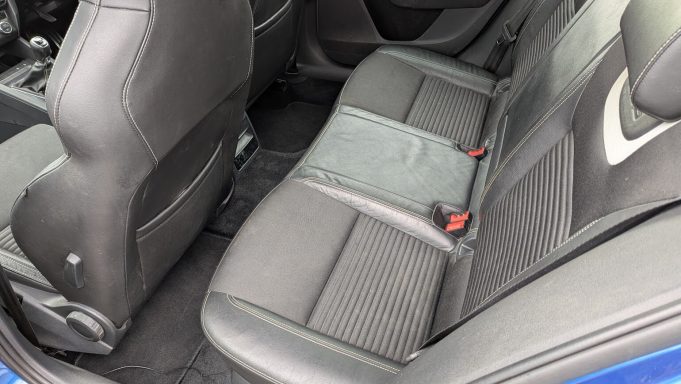 Rear seats of a blue Skoda in Peterborough, Cambridgeshire after interior detailing, cleaned with fabrics refreshed and debris removed