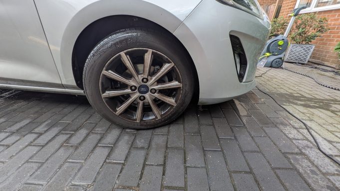 Close-up of a Ford Fiesta alloy wheel in Barnack, Peterborough before detailing, showing heavy brake dust and dirt buildup on the spokes.