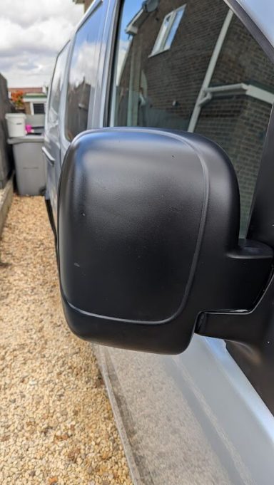 Restored black wing mirror on a Citroën Berlingo van in Peterborough after trim treatment
