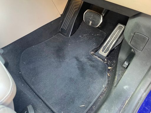 BMW iX1 driver footwell before interior detailing and extraction in Wittering, Peterborough