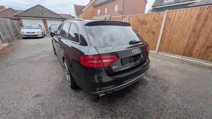 Rear of a black Audi S4 Avant in Huntingdon, Cambridgeshire after detailing, with gloss restored and exhaust tips polished.