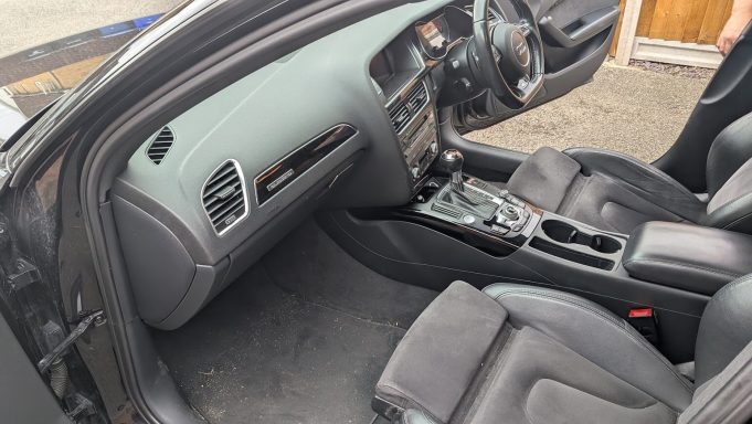 Audi S4 passenger interior before detailing in Huntingdon, Cambridgeshire Audi S4 passenger side interior in Huntingdon before detailing, with visible debris and dirt on carpets.